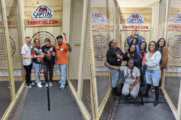 Photos of family and friends at an axe throwing venue