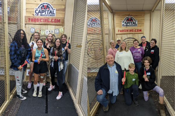 two photos of birthday party groups axe throwing