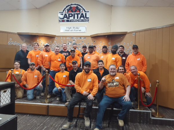 a corporate group at an axe throwing venue