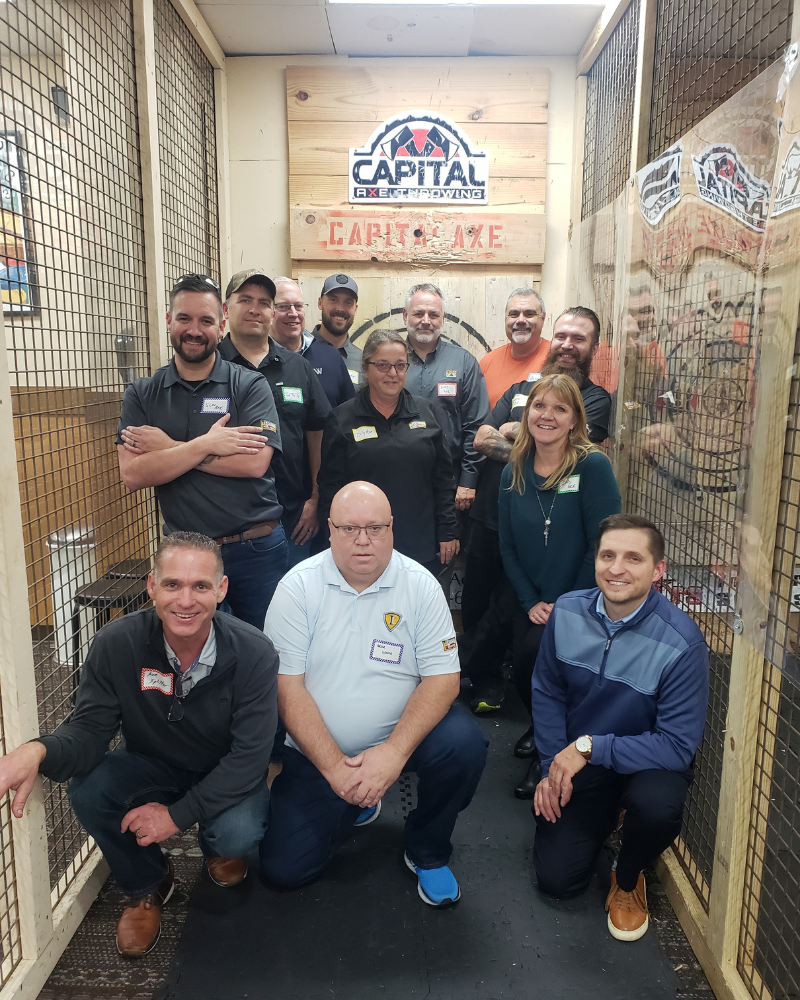 Photo of a group of work colleagues at an axe-throwing venue